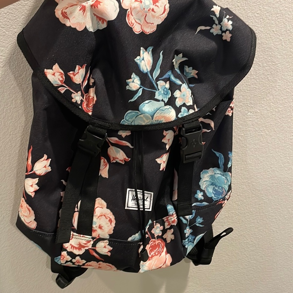 Brand new Herschel backpack with tags. Never used . Blue with flowers .